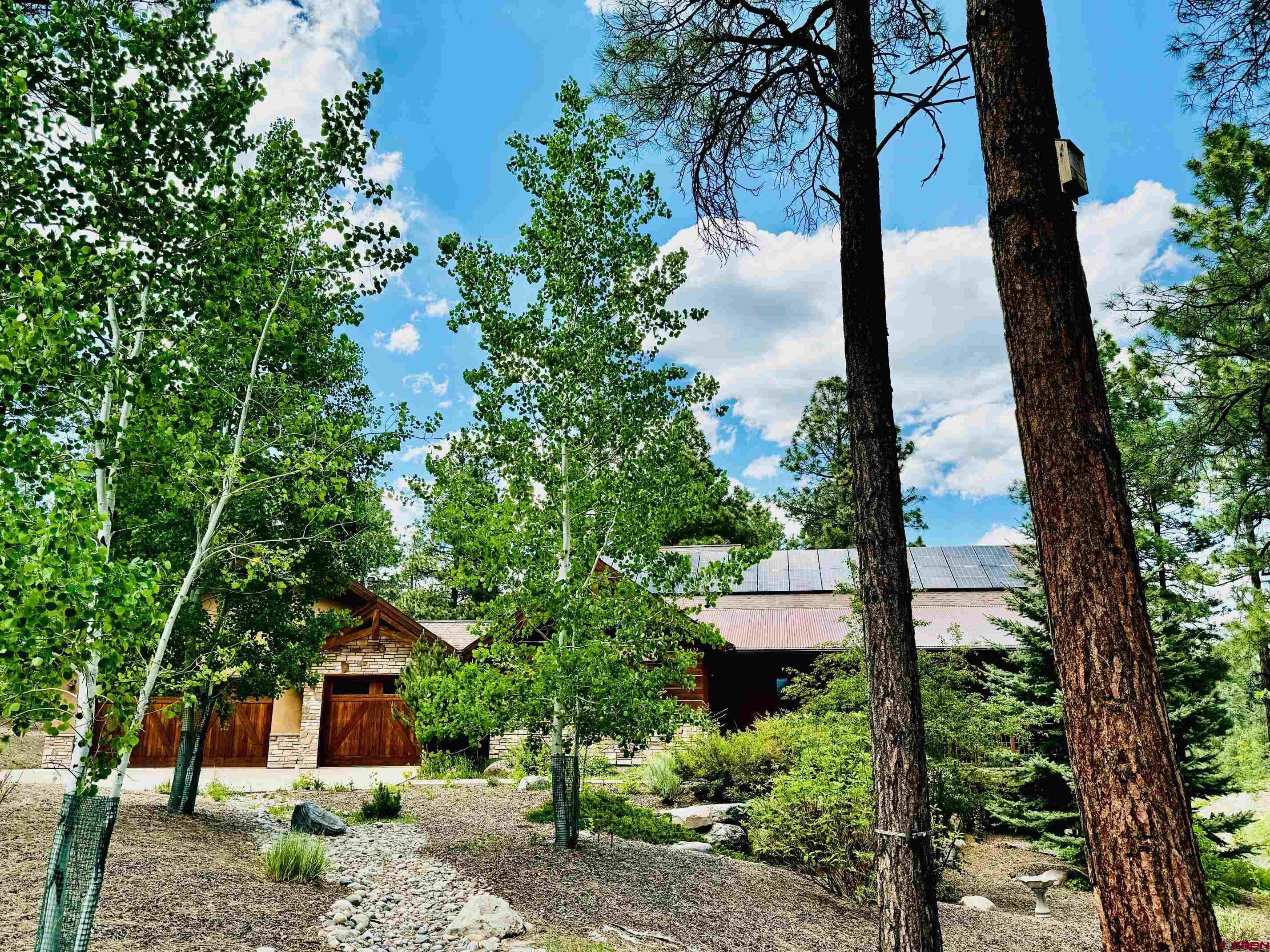 680 The Golden Dipper Road Durango, CO 81301 - Photo 35 of 35 a view of a garden with a tree