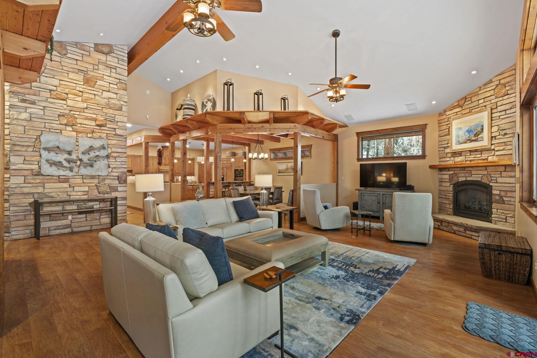 680 The Golden Dipper Road Durango, CO 81301 - Photo 4 of 35 a living room with furniture a fireplace and a chandelier