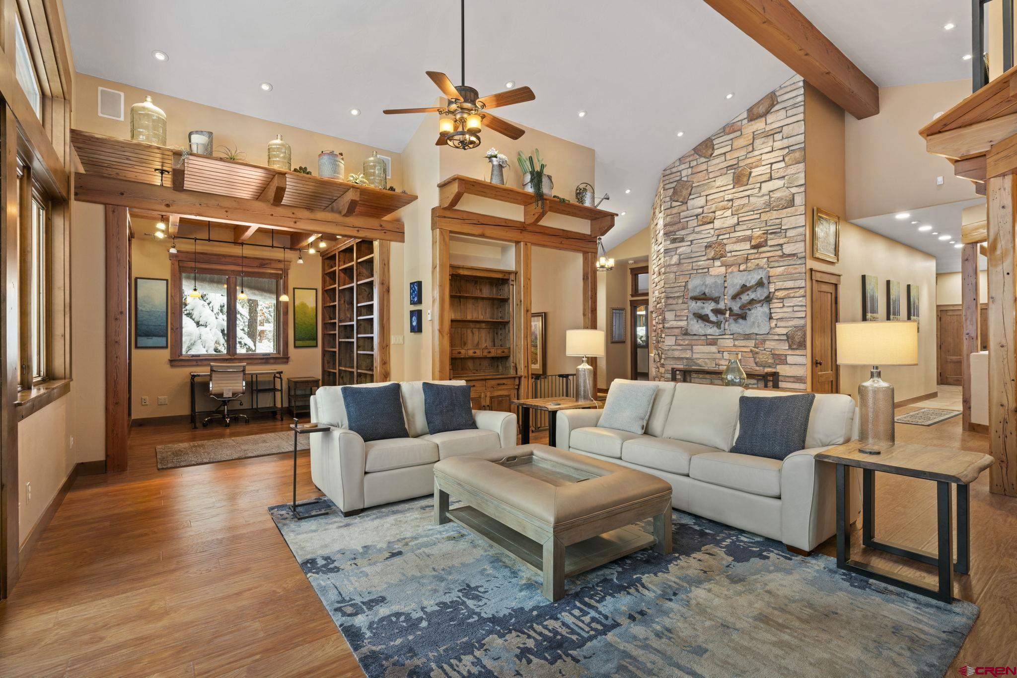 680 The Golden Dipper Road Durango, CO 81301 - Photo 5 of 35 a living room with furniture wooden floor and a large window