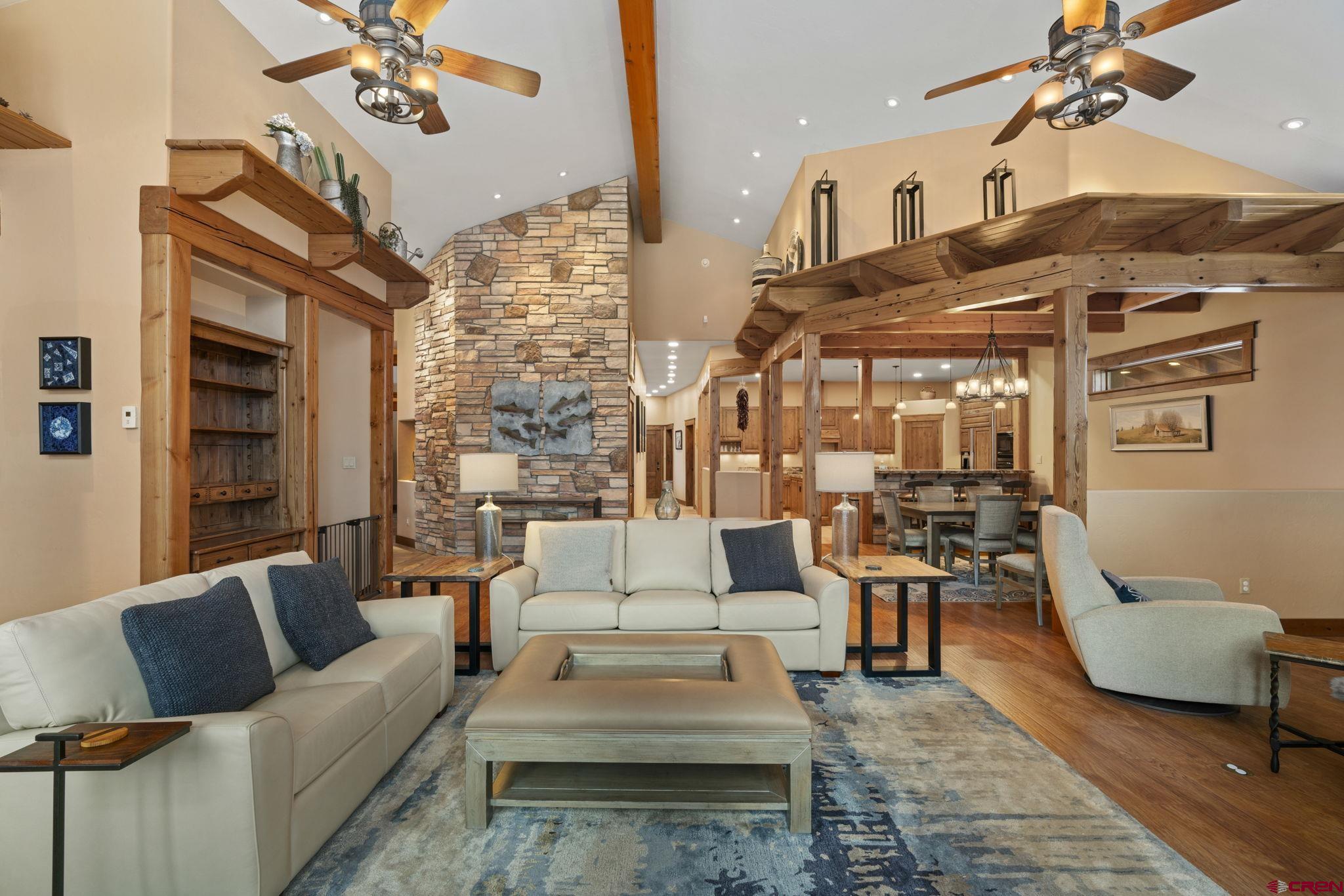 680 The Golden Dipper Road Durango, CO 81301 - Photo 6 of 35 a living room with furniture a rug and a chandelier