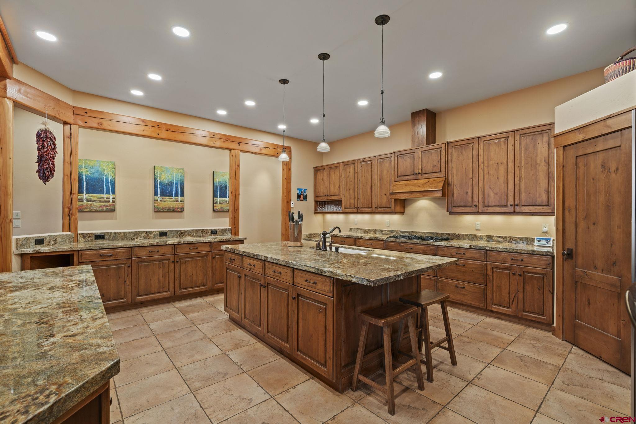 680 The Golden Dipper Road Durango, CO 81301 - Photo 9 of 35 a kitchen with granite countertop a sink counter top space appliances and cabinets
