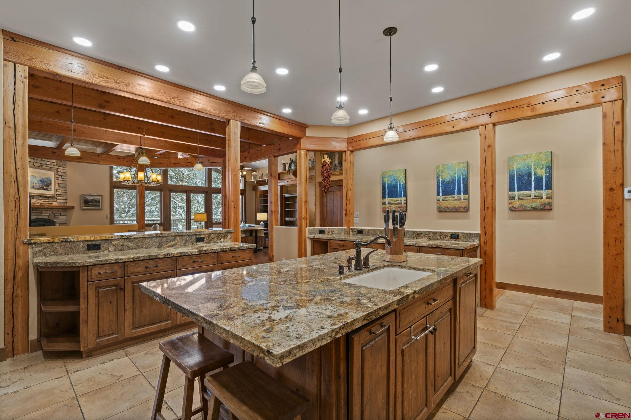 680 The Golden Dipper Road Durango, CO 81301 - Photo 10 of 35 a kitchen with center island table and chairs