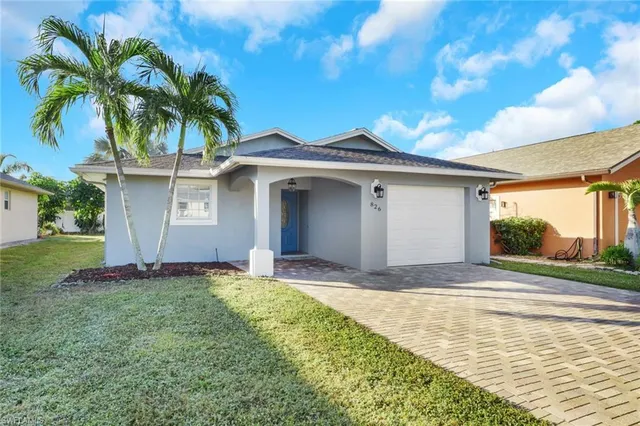 a front view of a house with a garden and entryway
