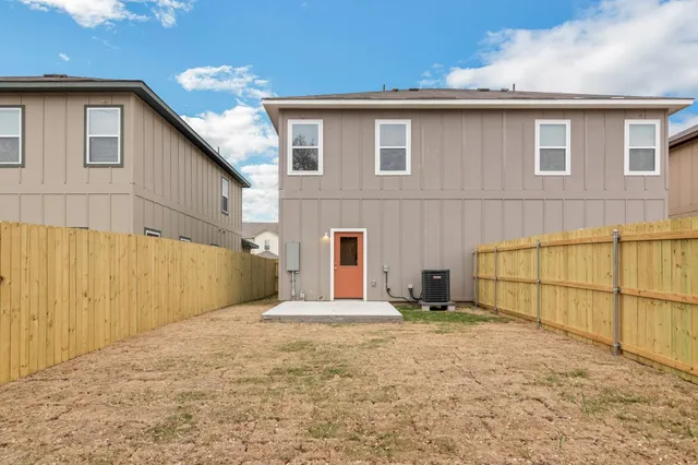 a view of a yard with wooden fence