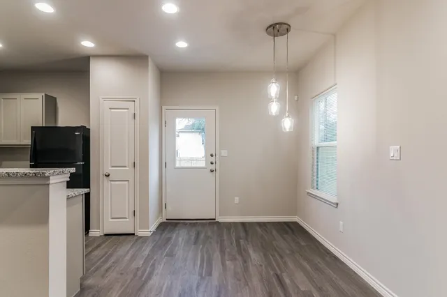 a kitchen with stainless steel appliances granite countertop a refrigerator and a sink