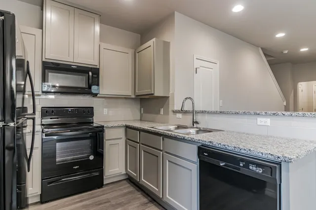 a view of empty room with wooden floor and window
