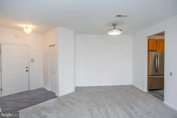 a view of empty room with wooden floor and closet