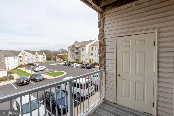 a view of a balcony with yard