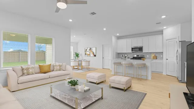 a living room with furniture and kitchen view