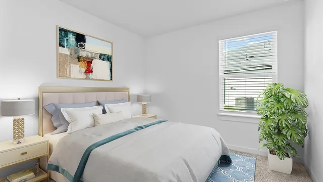 a bedroom with bed and a potted plant