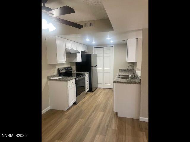 7680 Bluestone Drive, Unit 371 Reno, NV 89511 - Photo 1 of 14 a kitchen with a sink stainless steel appliances and cabinets