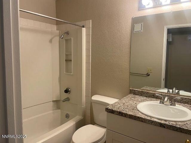 7680 Bluestone Drive, Unit 371 Reno, NV 89511 - Photo 12 of 14 a bathroom with a granite countertop sink toilet mirror and shower
