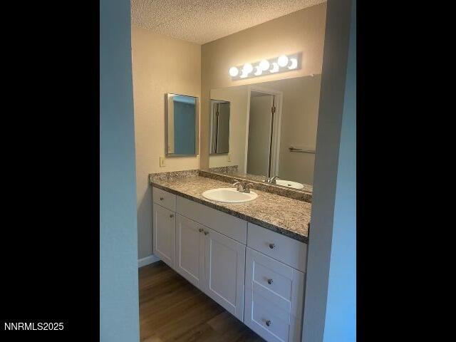 7680 Bluestone Drive, Unit 371 Reno, NV 89511 - Photo 2 of 14 a bathroom with a granite countertop sink and a mirror