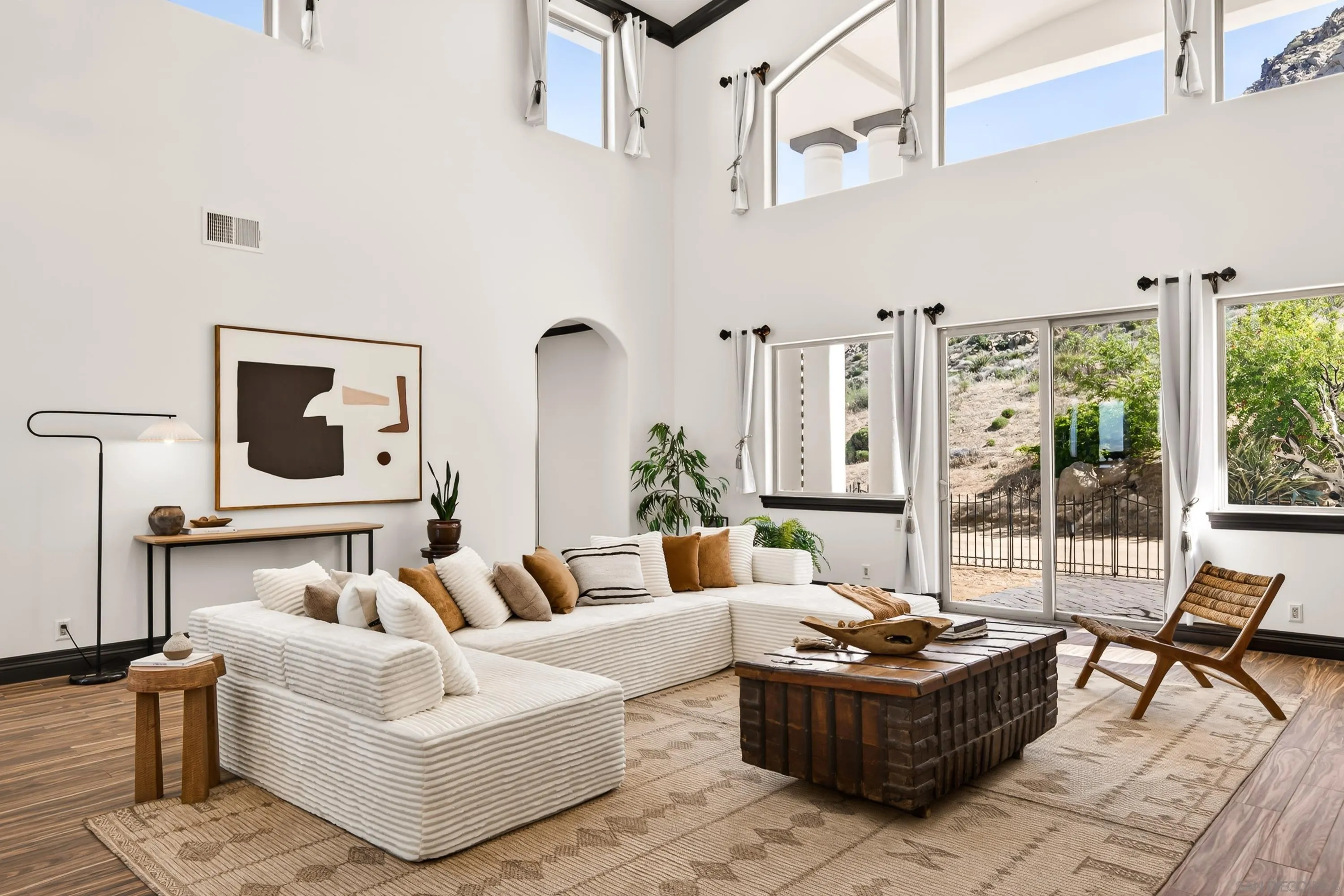 8022 Wesley Road Joshua Tree, CA 92252 - Photo 22 of 69 a living room with furniture and a floor to ceiling window
