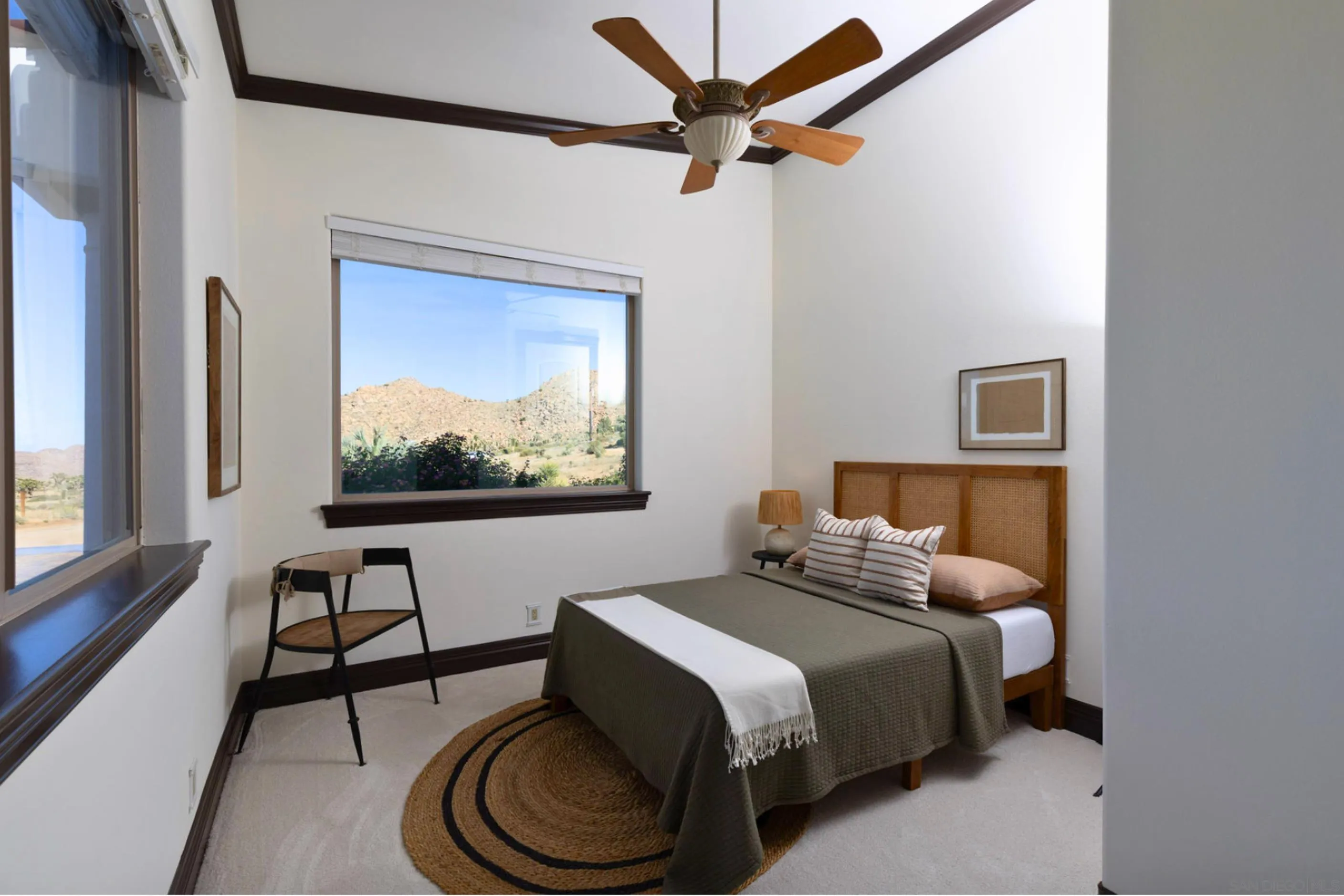 8022 Wesley Road Joshua Tree, CA 92252 - Photo 26 of 69 a bedroom with a bed and a painting on the wall