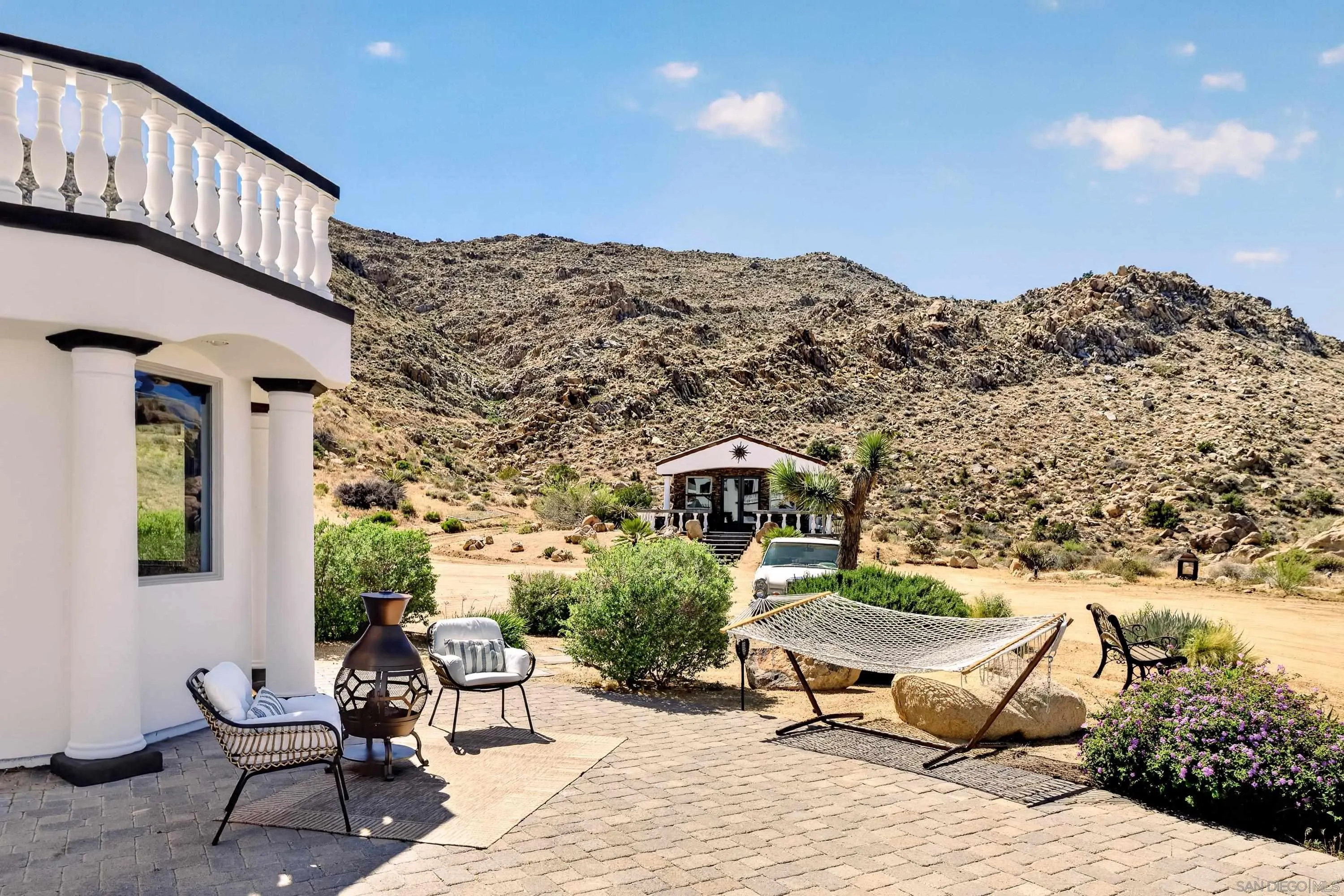 8022 Wesley Road Joshua Tree, CA 92252 - Photo 48 of 69 a roof deck with table and chairs and potted plants