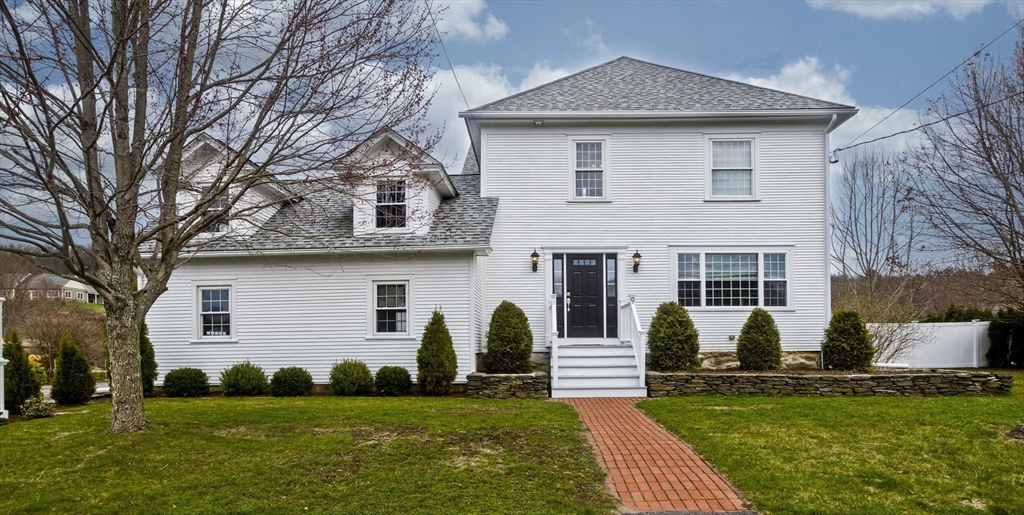 a front view of a house with a yard