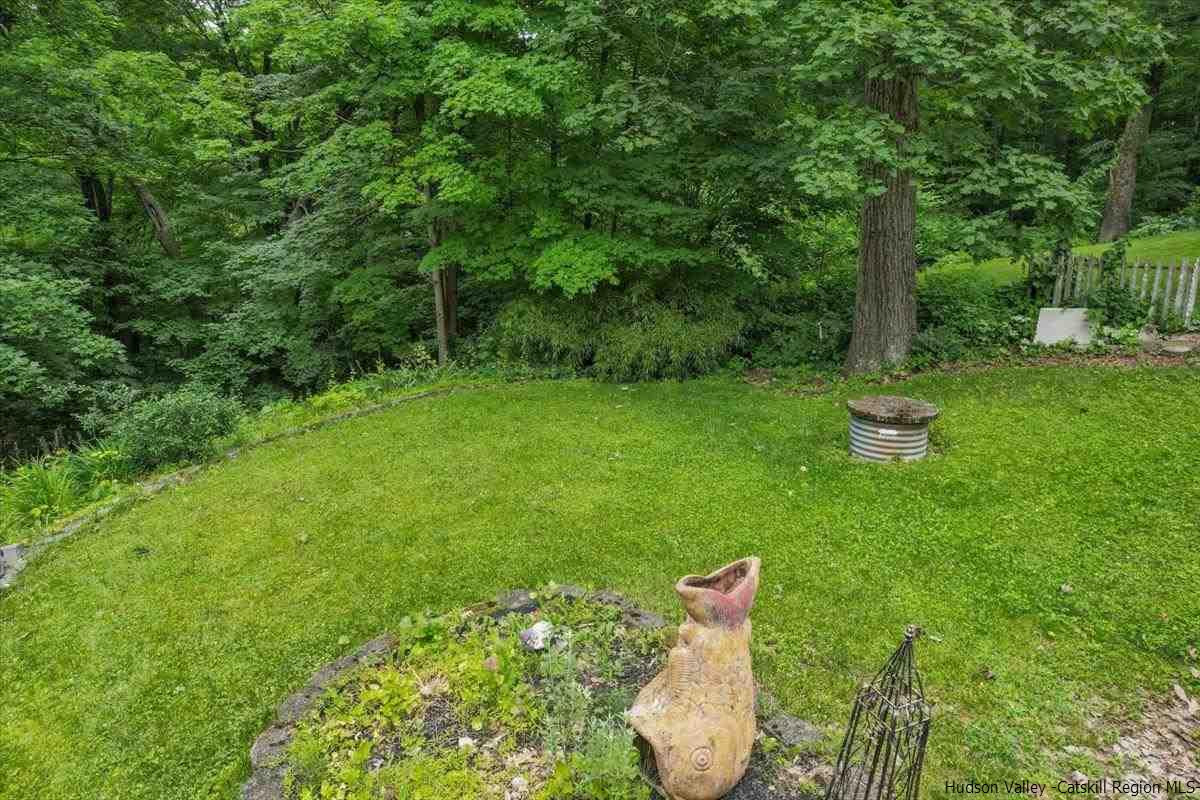 36 Cooper Road Monroe, NY 10950 - Photo 11 of 25 a backyard of a house with lots of green space and a fountain