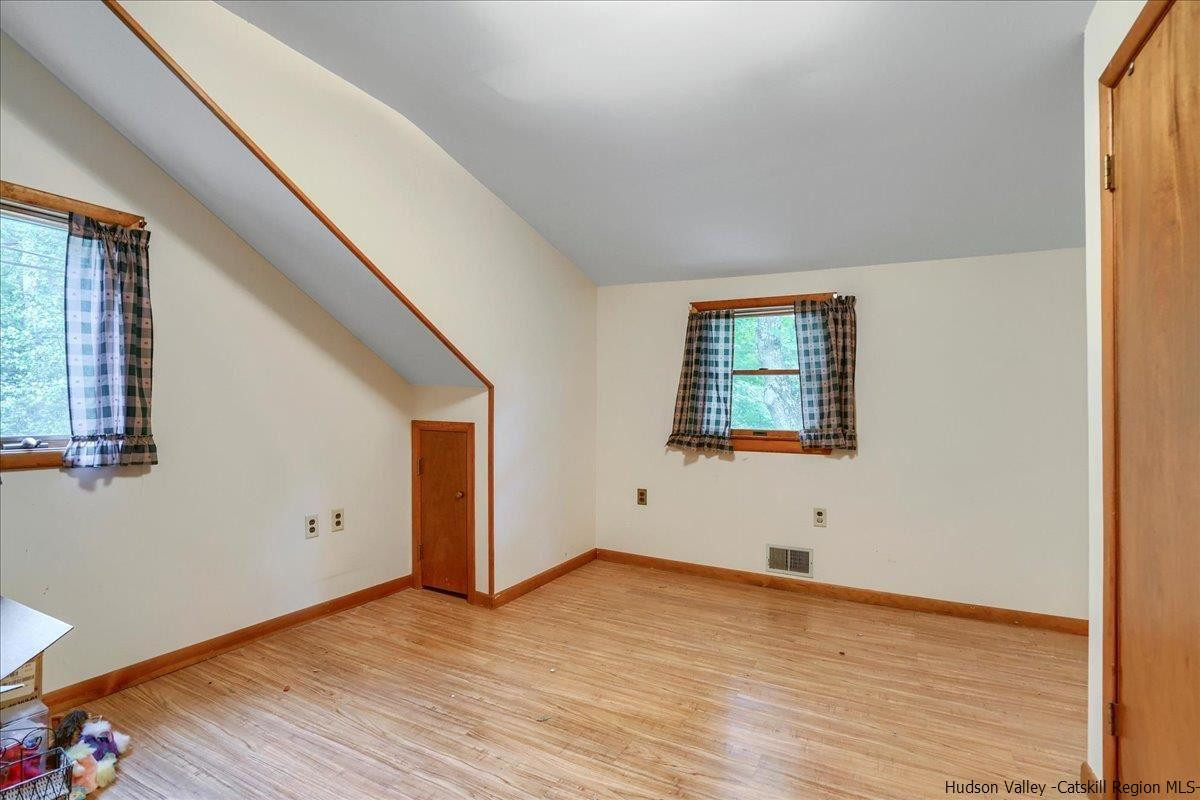 36 Cooper Road Monroe, NY 10950 - Photo 14 of 25 a view of an empty room with wooden floor and windows