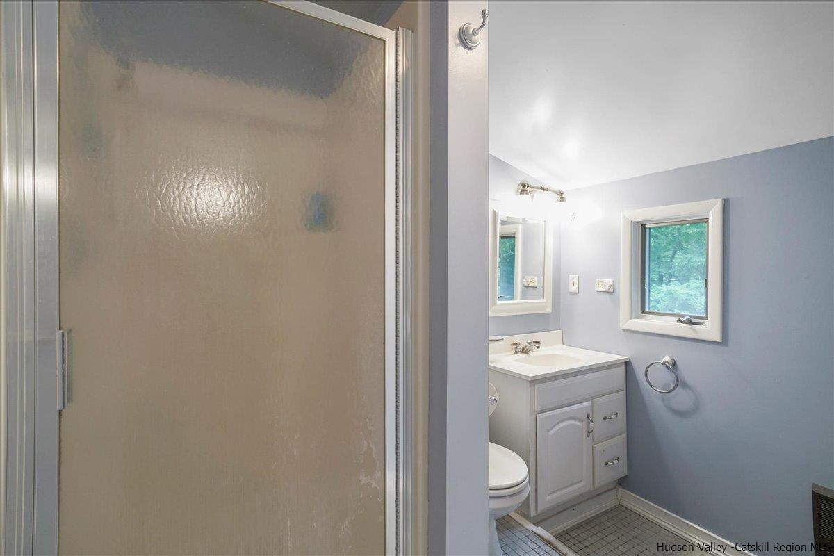 36 Cooper Road Monroe, NY 10950 - Photo 16 of 25 a bathroom with a sink a toilet and shower