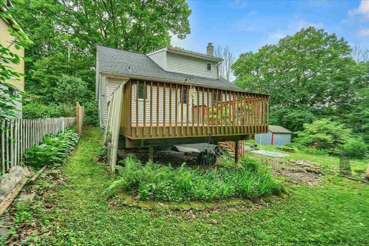 36 Cooper Road Monroe, NY 10950 - Photo 19 of 25 a view of a brick house with a small yard plants and large trees