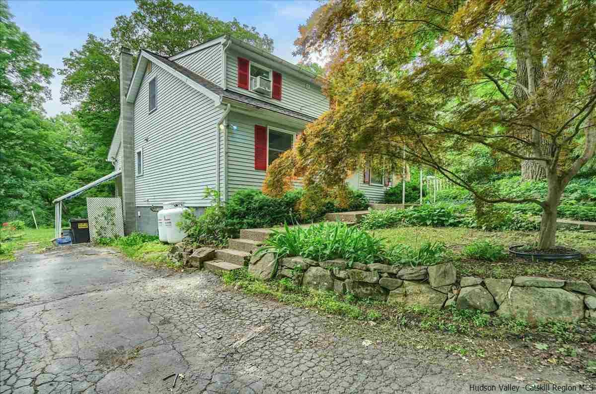 36 Cooper Road Monroe, NY 10950 - Photo 3 of 25 a view of a house with a yard and plants