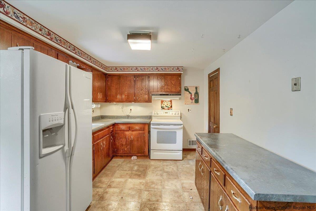 36 Cooper Road Monroe, NY 10950 - Photo 4 of 25 a kitchen with stainless steel appliances granite countertop a refrigerator sink and stove
