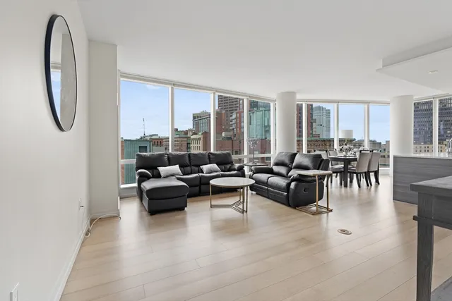 a living room with furniture and floor to ceiling windows