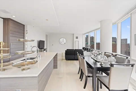 a kitchen with a dining table and chairs