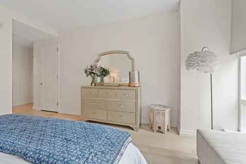 a bedroom with a bed and a dresser