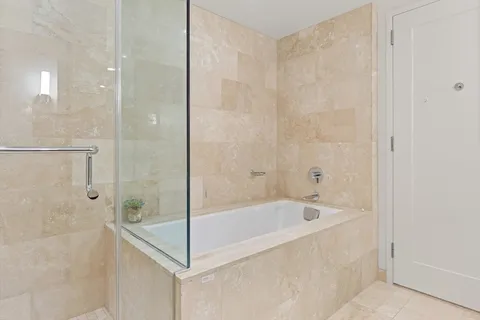 a bathroom with a bathtub and shower