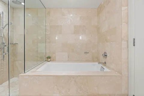 a bathroom with a bathtub and shower