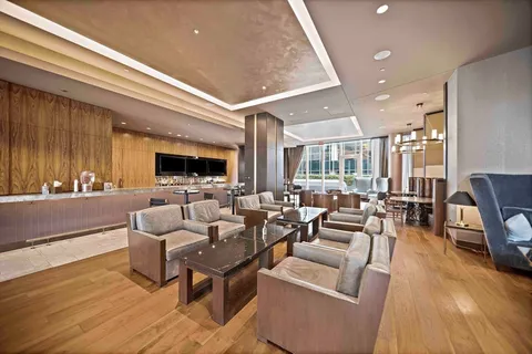 a living room with lots of furniture and a view of kitchen