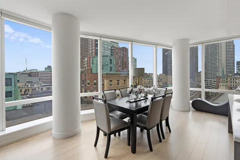 a dining room with furniture and wooden floor