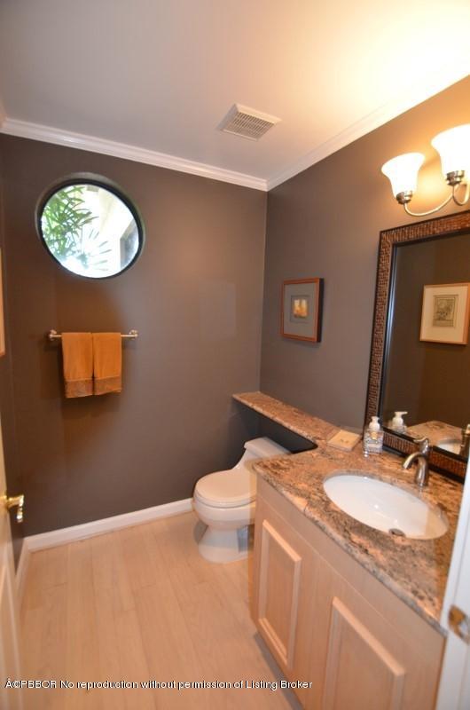 2213 Northwest 60th Road Boca Raton, FL 33496 - Photo 17 of 45 a bathroom with a sink a mirror and a toilet