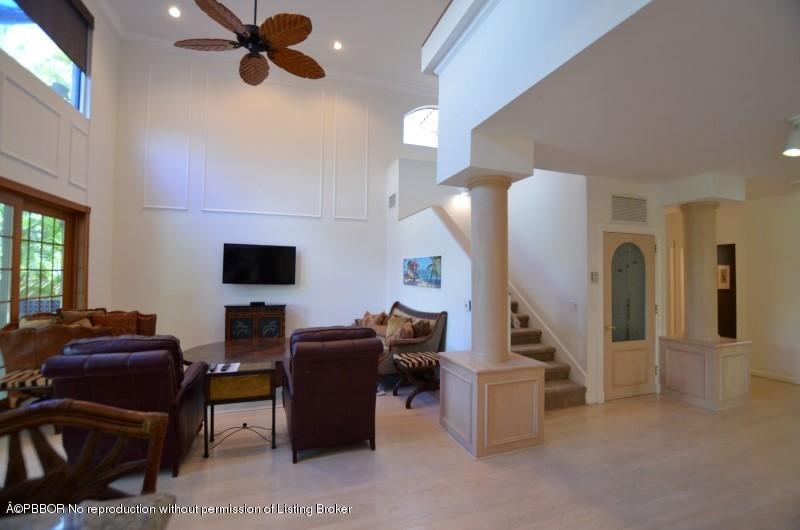 2213 Northwest 60th Road Boca Raton, FL 33496 - Photo 18 of 45 a living room with couches and a flat screen tv with kitchen view