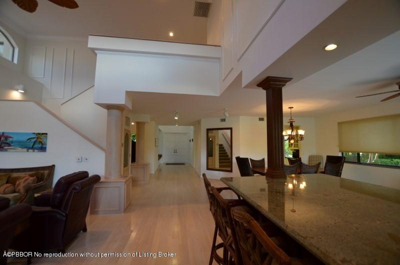 2213 Northwest 60th Road Boca Raton, FL 33496 - Photo 3 of 45 a dining hall with couches a flat tv screen and a dining table with garden view