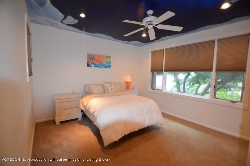 2213 Northwest 60th Road Boca Raton, FL 33496 - Photo 24 of 45 a bedroom with a bed and a large window