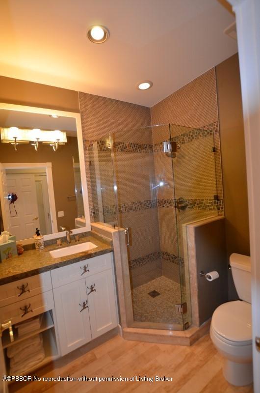 2213 Northwest 60th Road Boca Raton, FL 33496 - Photo 25 of 45 a bathroom with a granite countertop sink mirror toilet and shower