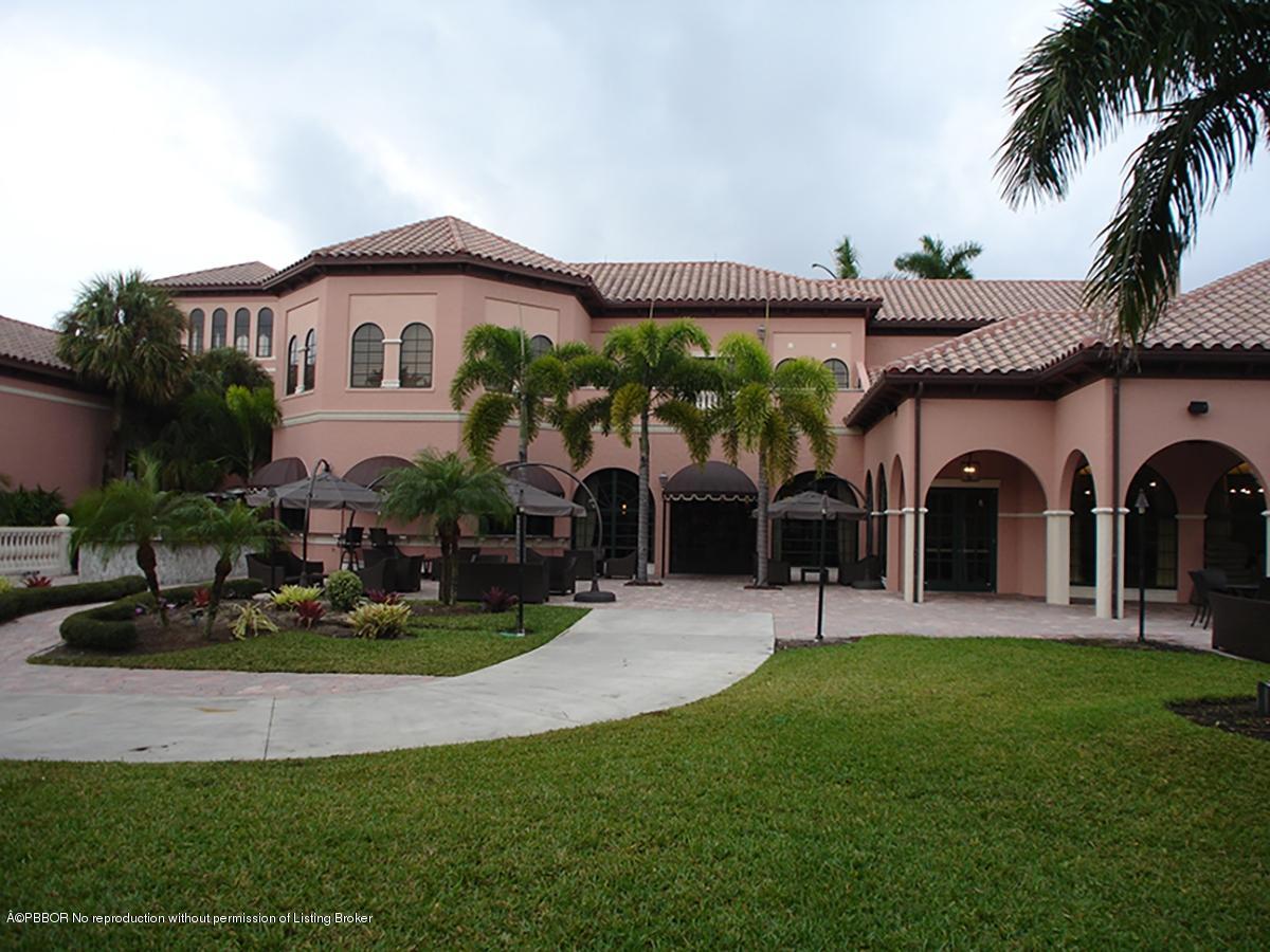 2213 Northwest 60th Road Boca Raton, FL 33496 - Photo 39 of 45 a front view of a house with garden and a tree
