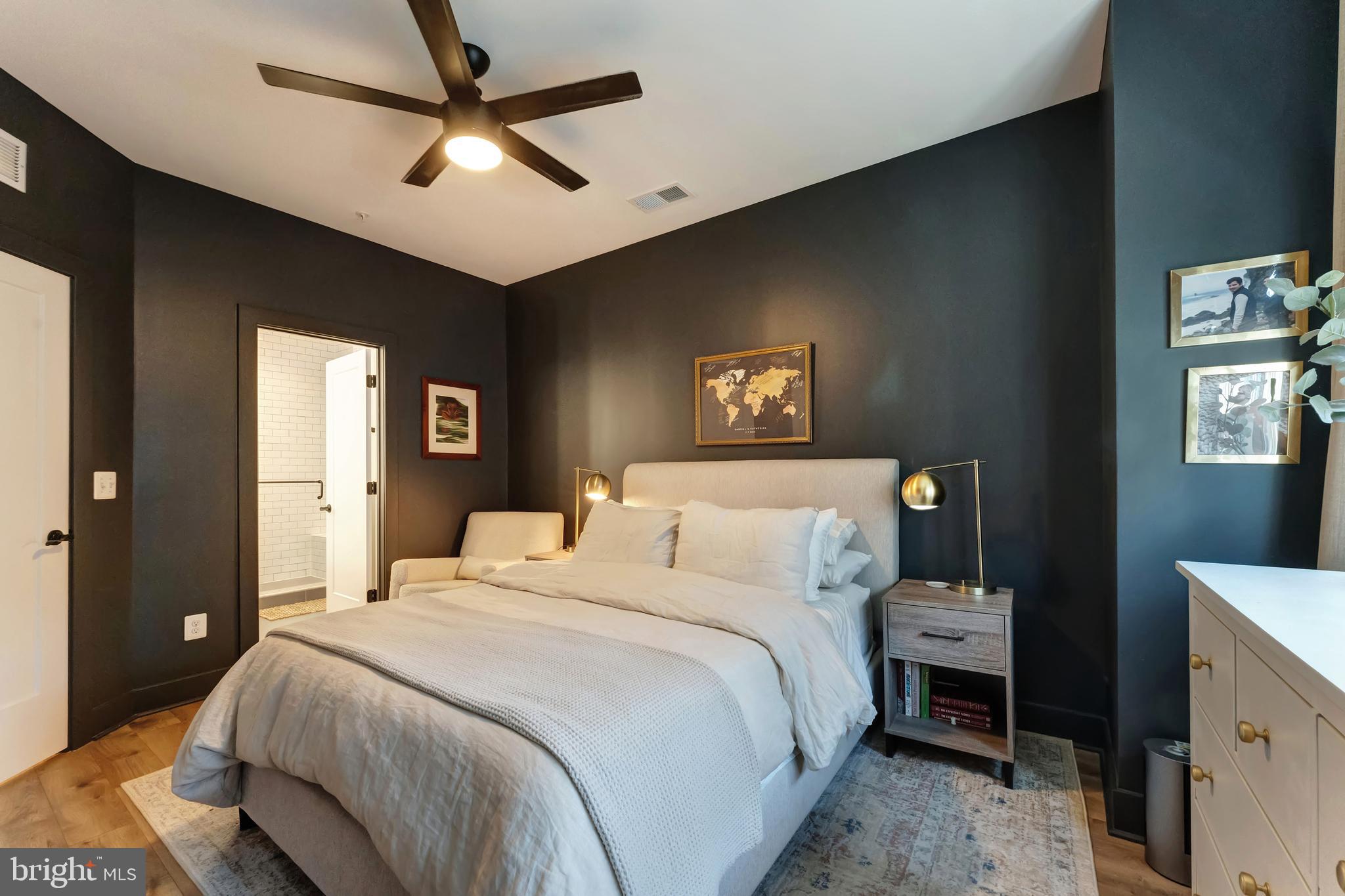 11237 Beaker Street Reston, VA 20190 - Photo 19 of 45 a bedroom with a bed and a chandelier