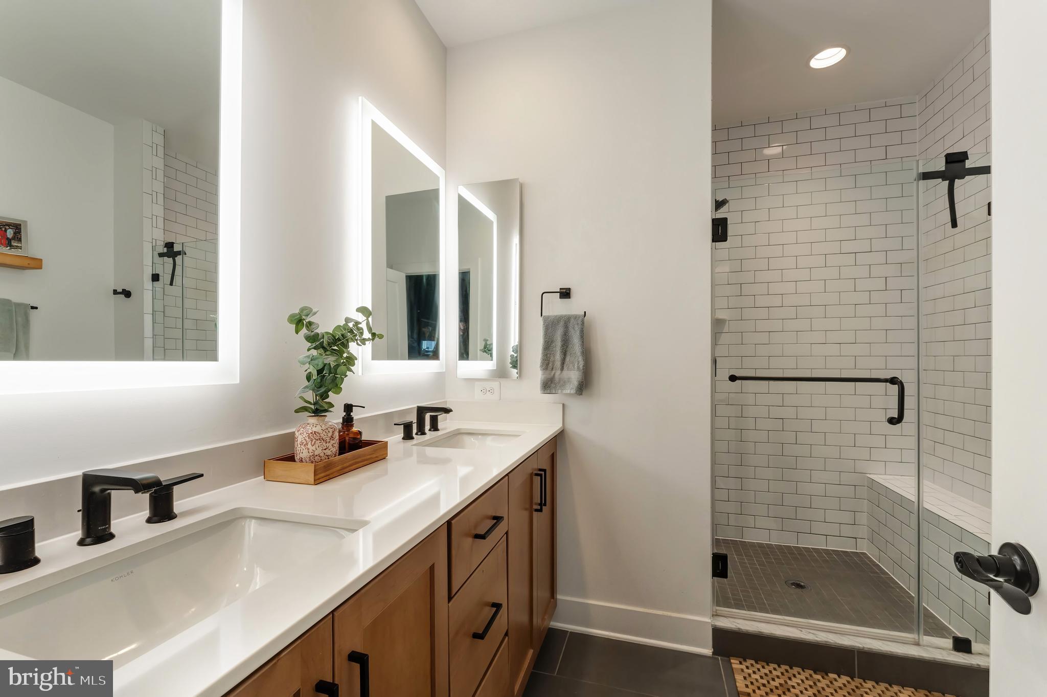 11237 Beaker Street Reston, VA 20190 - Photo 20 of 45 a bathroom with a shower sink and mirror