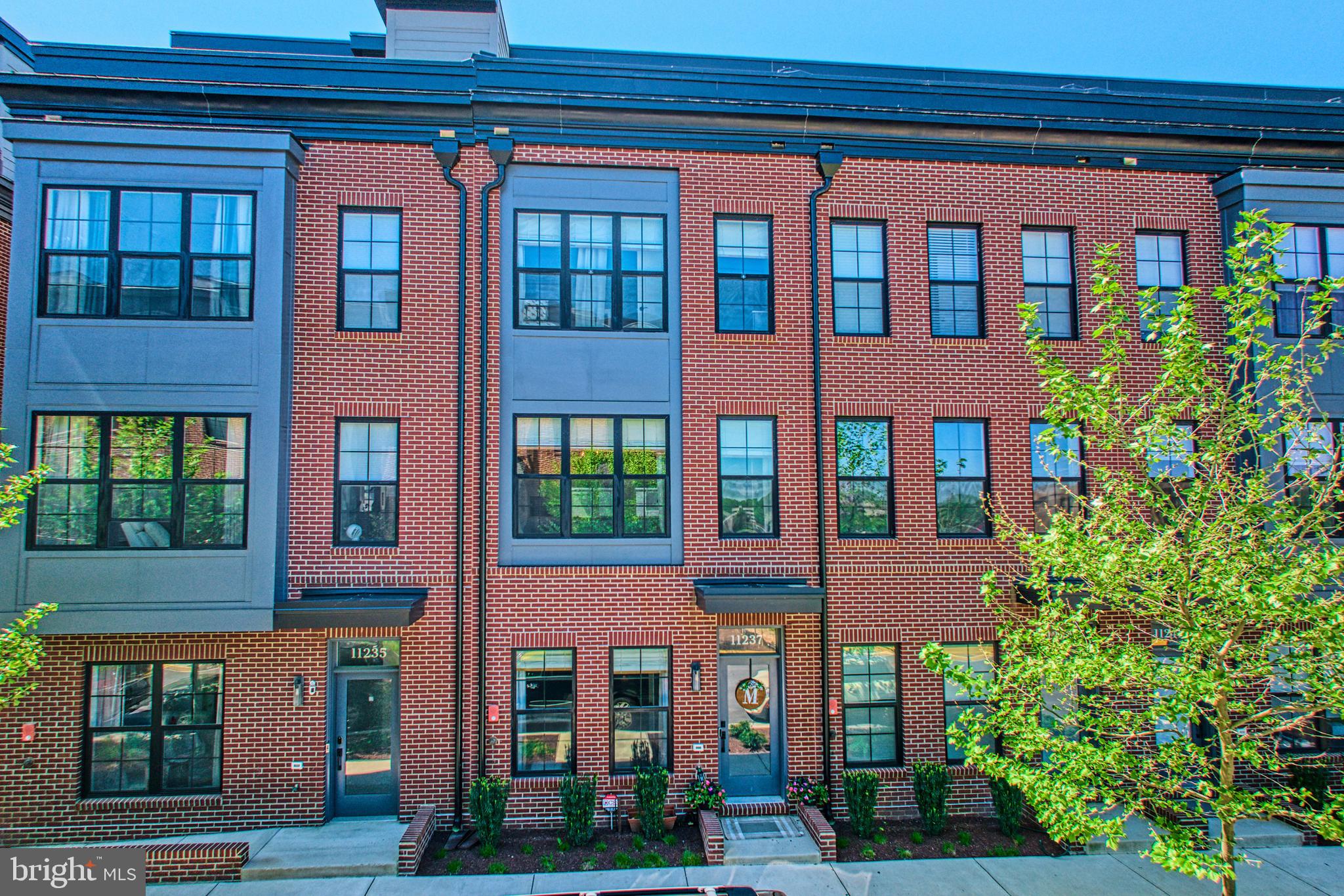 11237 Beaker Street Reston, VA 20190 - Photo 2 of 45 a front view of building with a garden
