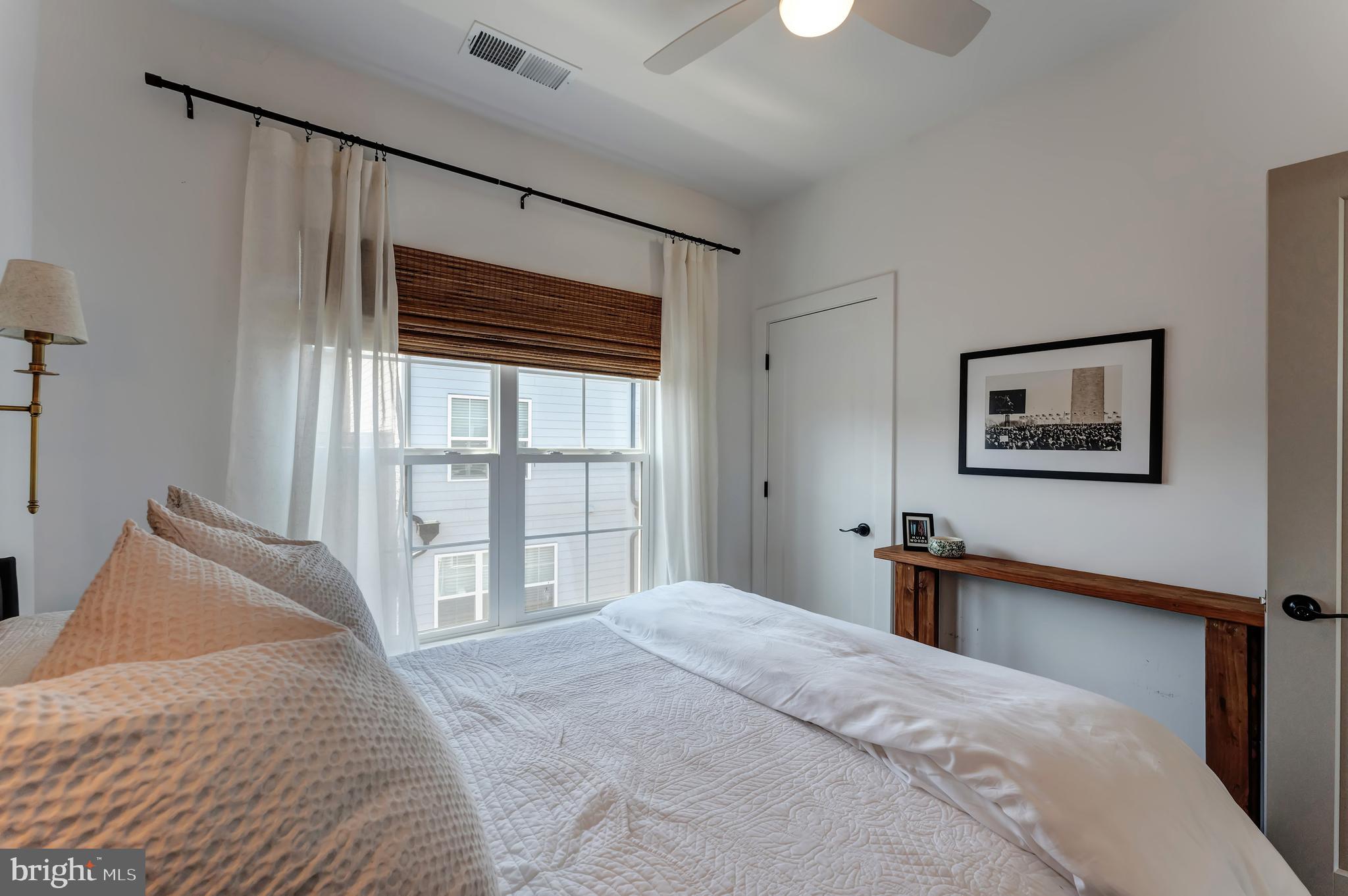 11237 Beaker Street Reston, VA 20190 - Photo 31 of 45 a bedroom with a large bed and a large window