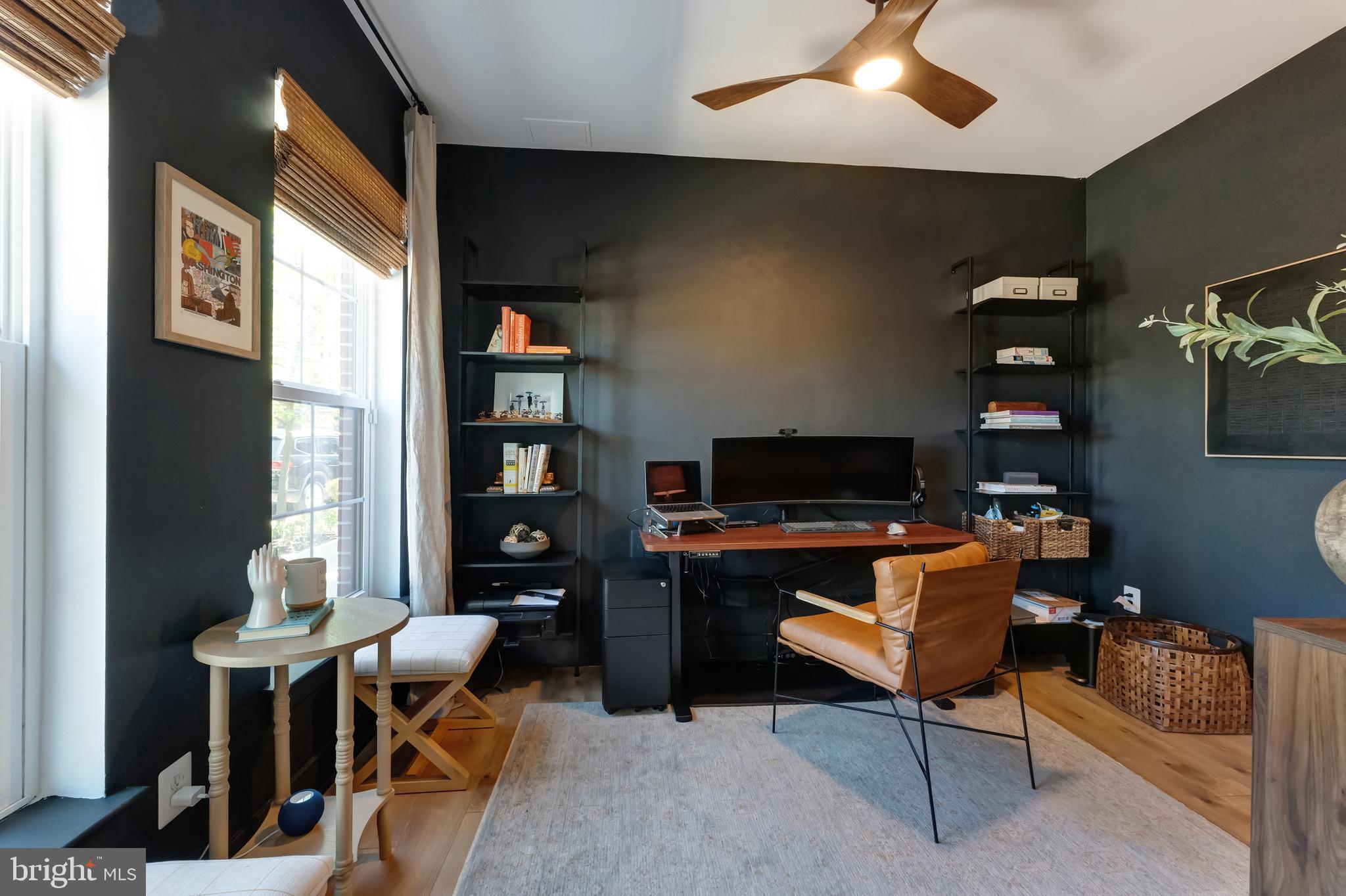 11237 Beaker Street Reston, VA 20190 - Photo 5 of 45 a living room with furniture a bookshelf and a flat screen tv