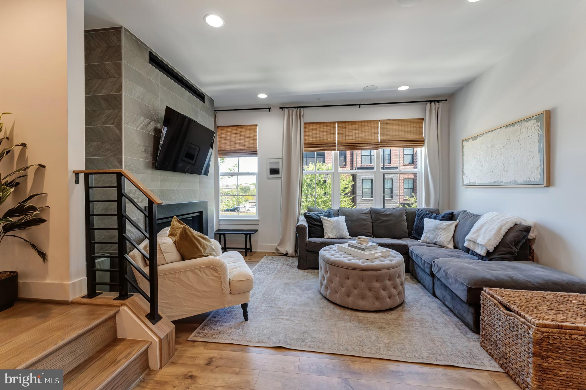 11237 Beaker Street Reston, VA 20190 - Photo 7 of 45 a living room with fireplace furniture and a flat screen tv