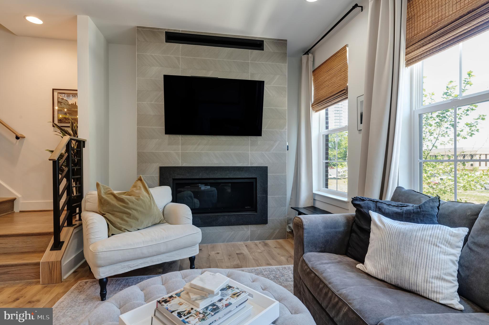 11237 Beaker Street Reston, VA 20190 - Photo 8 of 45 a living room with furniture a flat screen tv and a fireplace