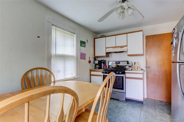 a kitchen with stainless steel appliances granite countertop a stove a refrigerator a sink a stove and island