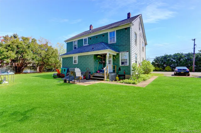 a view of a house with a yard porch and sitting area