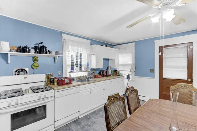 a kitchen with a refrigerator stove and white cabinets